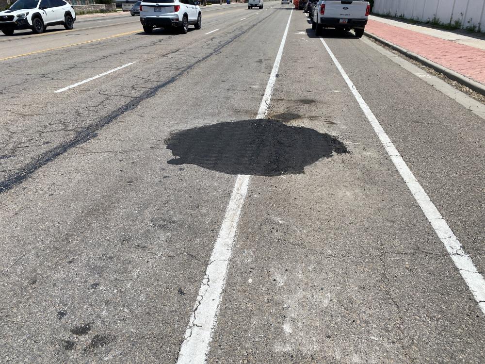 This lid has been lowered into the road surface and covered with temporary asphalt. This allows the equipment to drive and mill right over the lid, preventing damage to the equipment. 